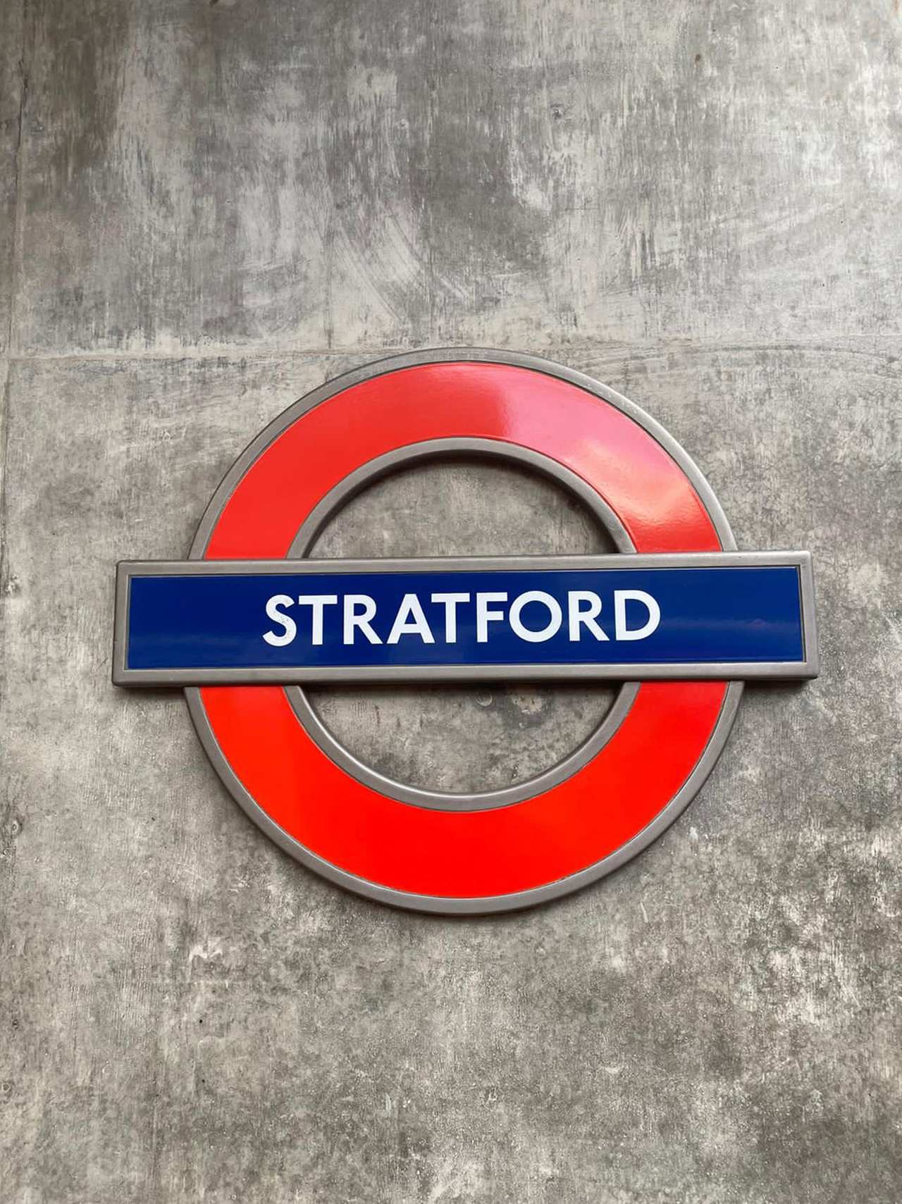 Stratford roundel sign on a concrete wall